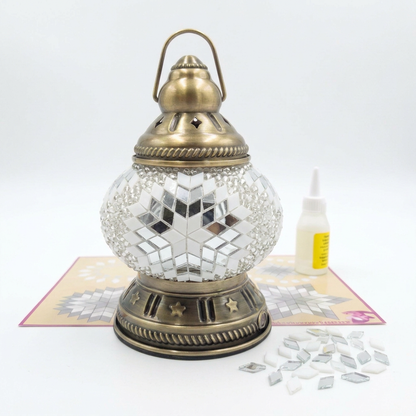 Melis mosaic lantern kit with placemat, glue and spare glass on a white background